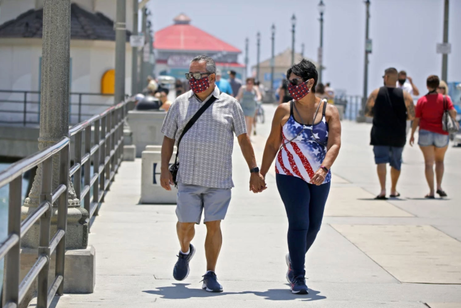 Danny Lopez of Chino Hills and Frances Pluma of Norwalk stroll on the pier in Huntington Beach in June 2020.(Raul Roa / Staff Photographer)