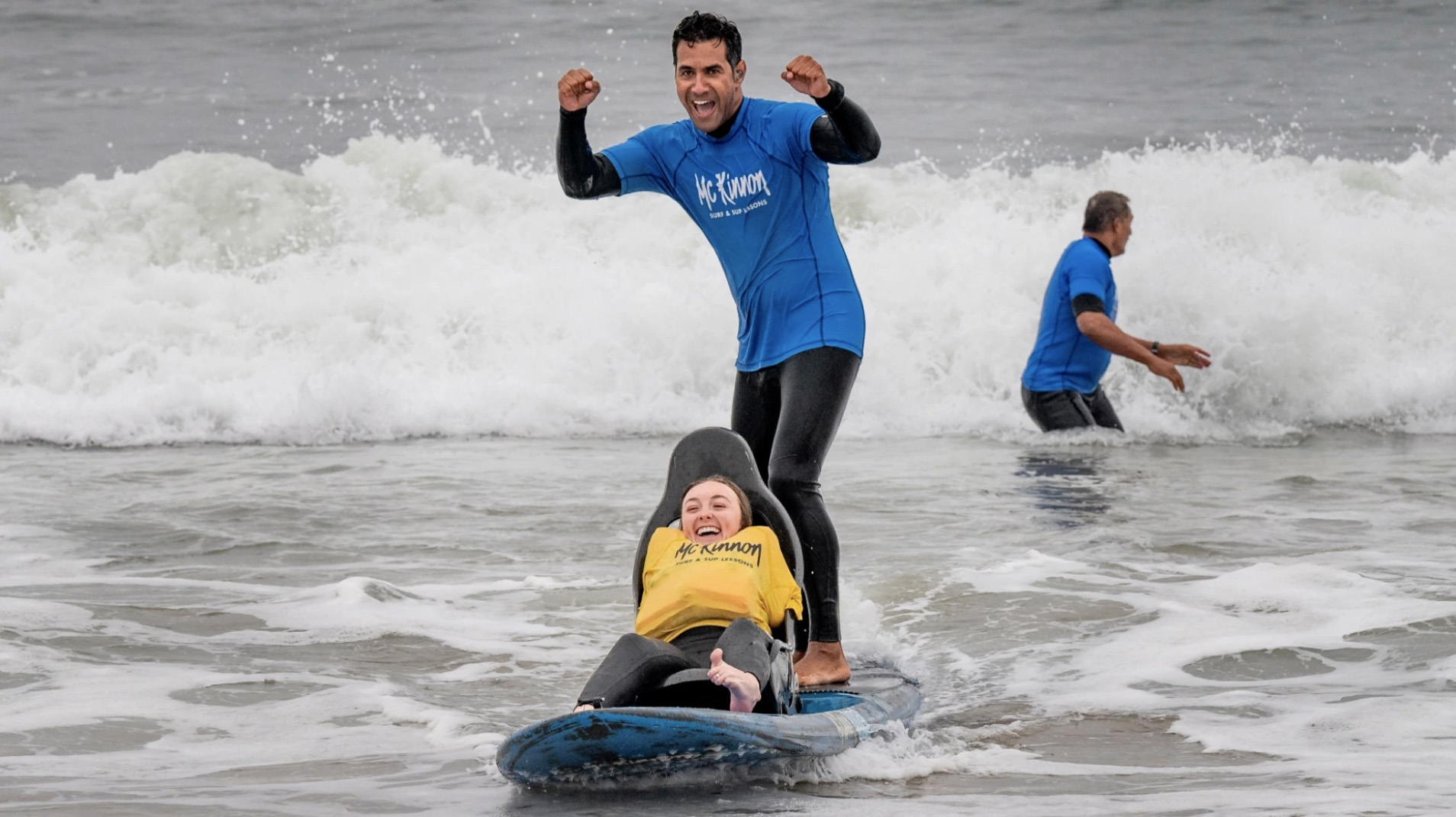 Emily Rowley, 20 takes a ride on a 15-foot chair board designed for adaptive surfing in Huntington Beach, CA on Friday, October 22, 2021. The board was developed by Rocky McKinnon, who runs McKinnon Surf & SUP Lessons. (Photo by Paul Bersebach, Orange County Register/SCNG)